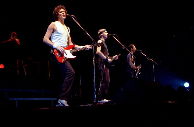 Dire Straits performing in Drammenshallen, Norway in 1985 (from left to right: John Illsley, Mark Knopfler, Jack Sonni). Photo: Helge Ã˜verÃ¥s/Wikimedia Commons