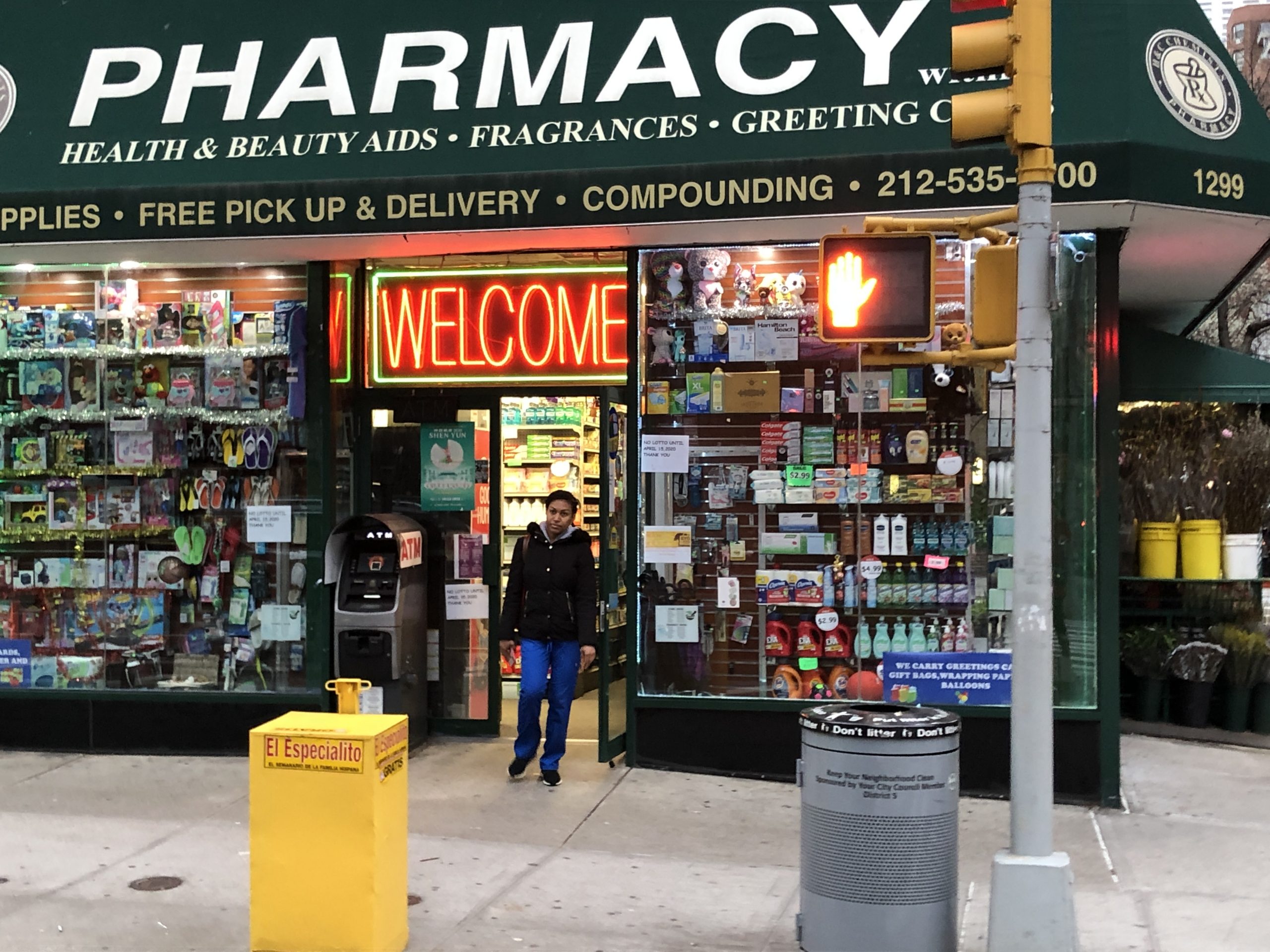 A nurse in her scrubs leaving the pharmacy, looking after herself as ...