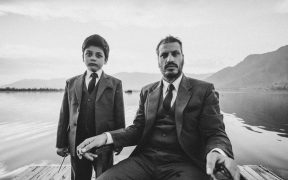 Alif Mohammad Muneem with a child actor by the backdrop of a lake