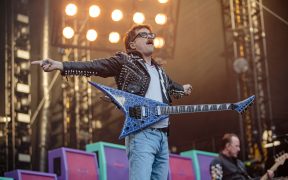 Weezer frontman Rivers Cuomo on stage with guitar