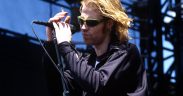 Mark Lanegan holding the mic and singing for Screaming Trees band on stage in concert