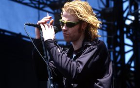 Mark Lanegan holding the mic and singing for Screaming Trees band on stage in concert