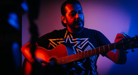 Guitar teacher and guitarist Sidharth Kadadi with an acoustic guitar