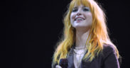Hayley Williams with orange hair and black shirt smiling