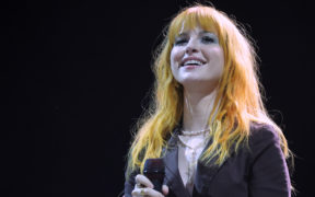 Hayley Williams with orange hair and black shirt smiling