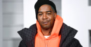 Kid Cudi in a black and orange jacket