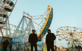 Dream Note band members standing in amusement park