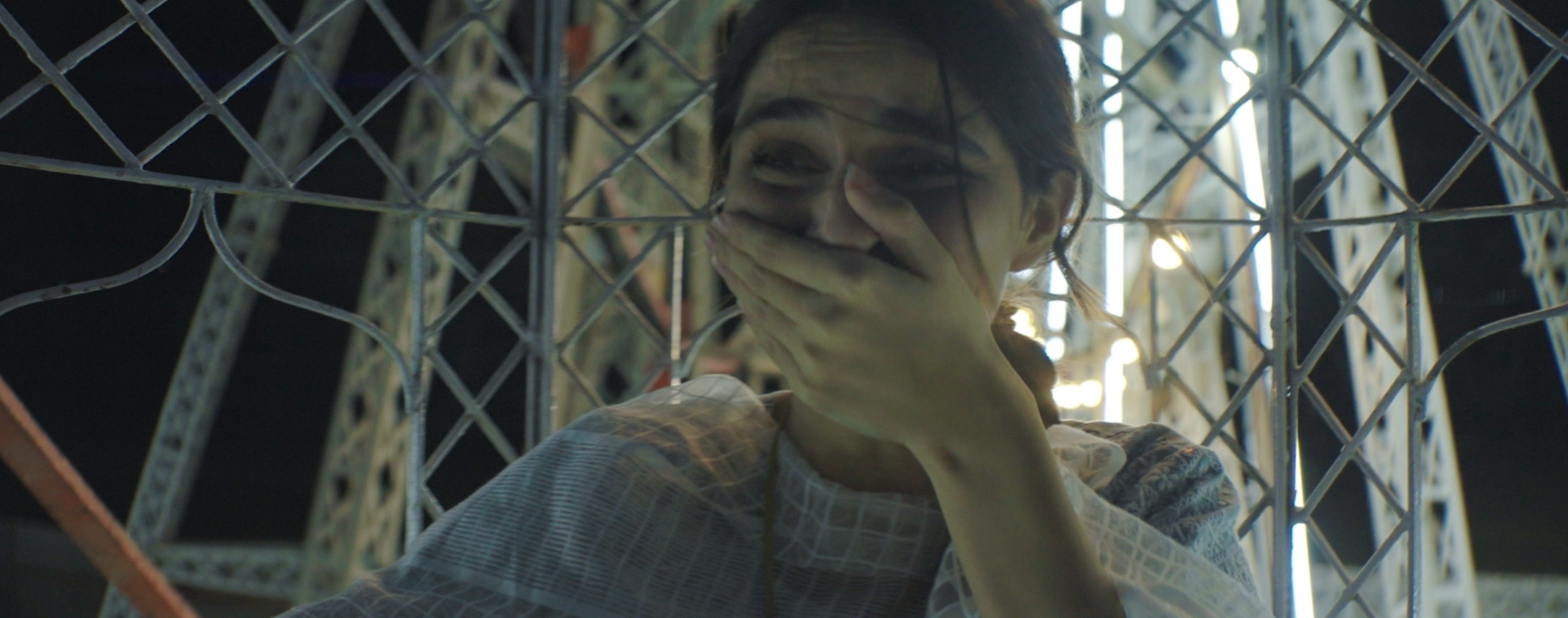 Aisha Ahmed in a ferris wheel ride with hand covering mouth