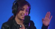 Shreya Ghoshal wearing headphones singing into mic