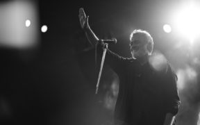 Black and white photo of Indian indie pop singer Lucky Ali waving to the audience in Bhopal