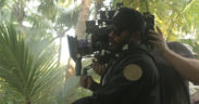 Ryan Coogler with a camera on the set in greenery for the movie Black Panther Wakanda Forever