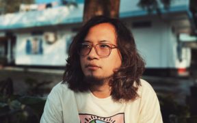 Arunachal singer-songwriter Taba Chake poses in a white T-shirt