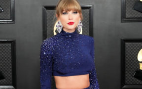 Taylor Swift attends the 65th GRAMMY Awards in a blue dress