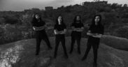 Black and white photo of death metal band Godless members standing on a mound