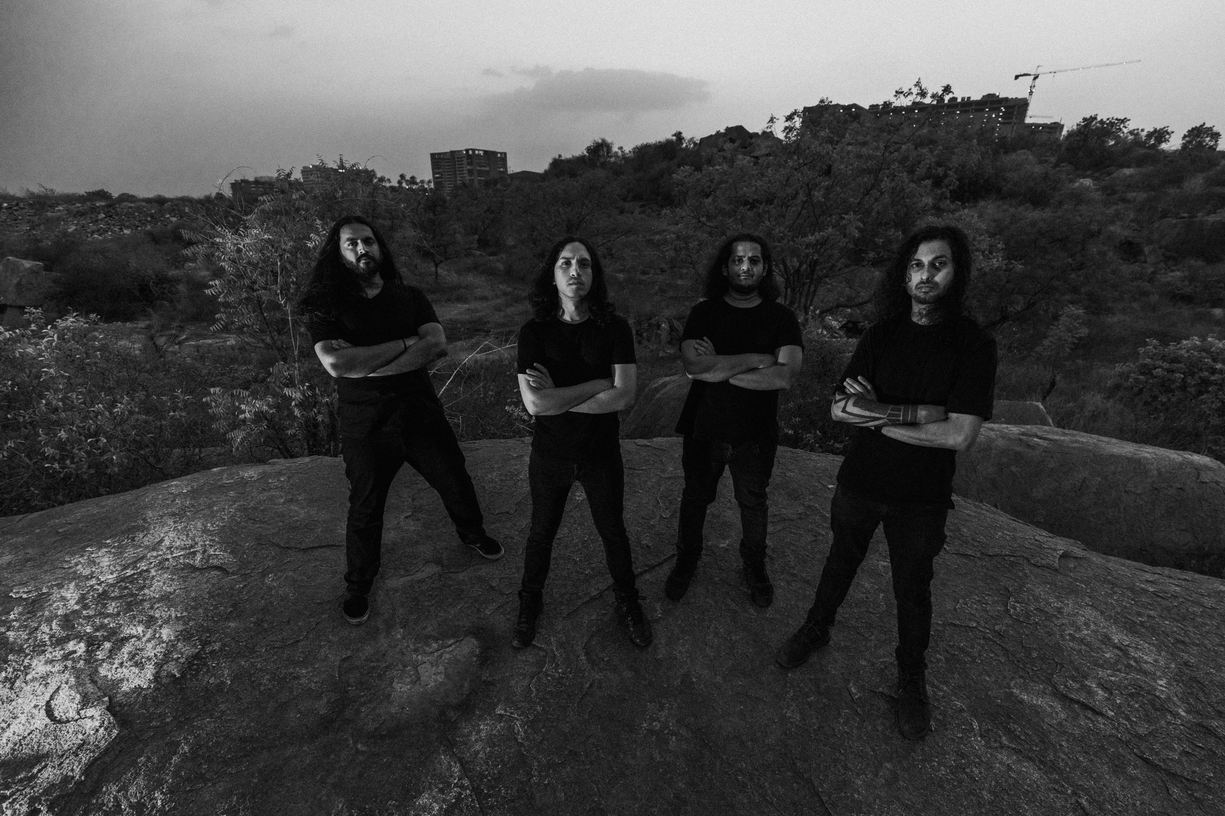 Black and white photo of death metal band Godless members standing on a mound