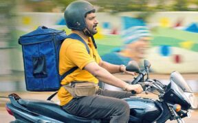 Kapil Sharma rides a motorbike in a still from the movie 'Zwigato'