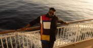 Kannada music artist All OK leaning on a rail on a ship cruise