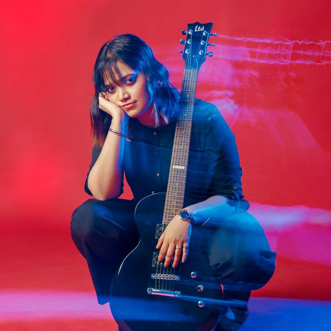 Music artist Reena Gilbert poses with a guitar