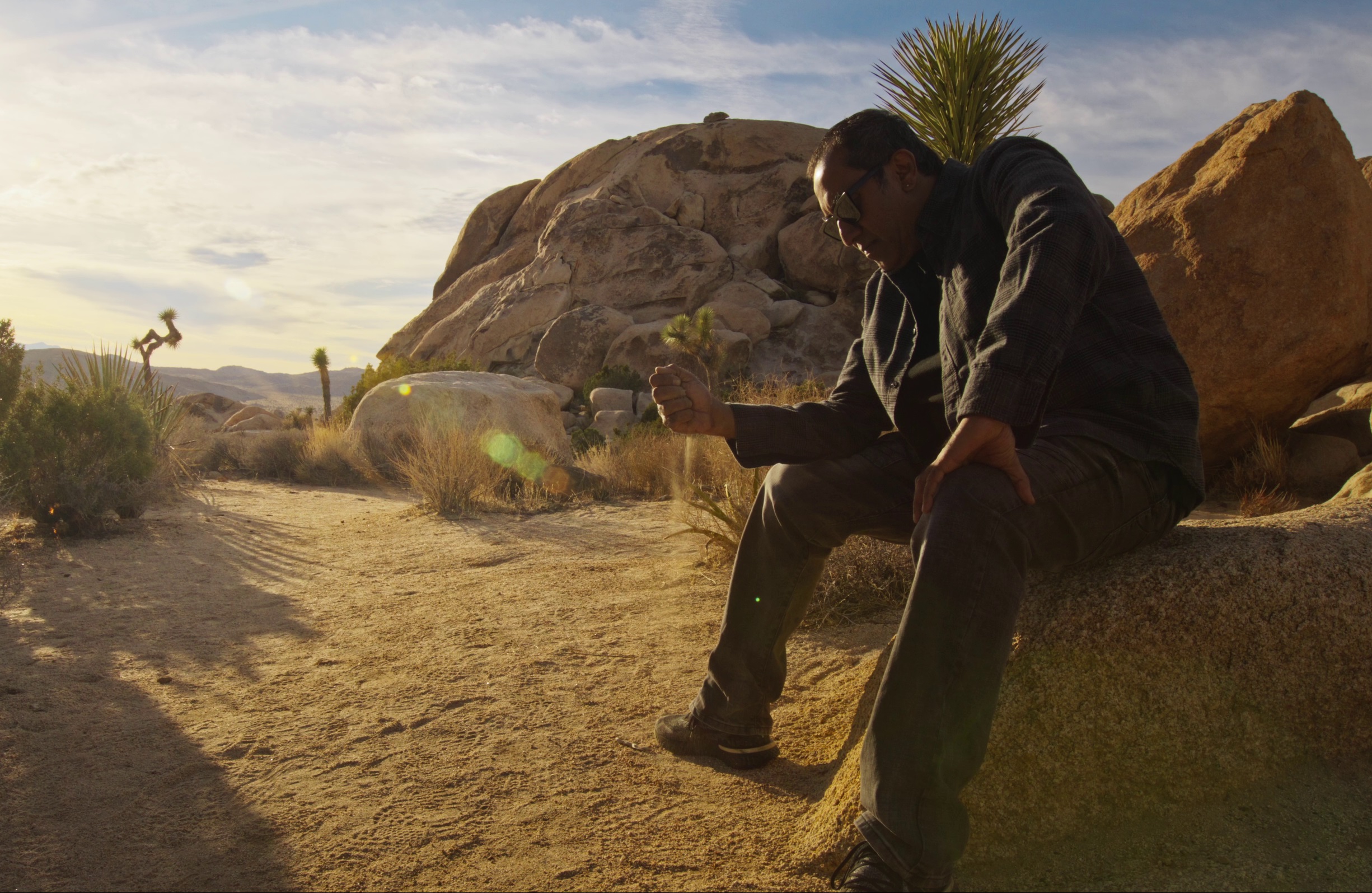 Mumbai-bred musician Sanjay Maroo sitting in Joshua Tree National Park in California for his music video Holding On