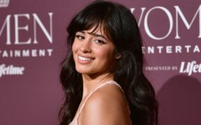 Camila Cabello smiles wearing a pink dress at a gala event in California