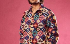 Darshan Raval in a multi color shirt posing with hands in pocket