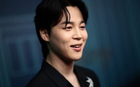 BTS Jimin smiles in a black suit