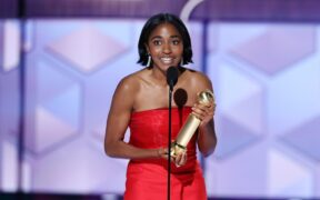 Ayo Edebiri in a red dress accepts Golden Globe award for The Bear