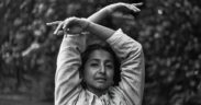 Singer-singwriter Ditty aka Aditi Veena in a black and white photo with arms raised