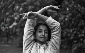 Singer-singwriter Ditty aka Aditi Veena in a black and white photo with arms raised