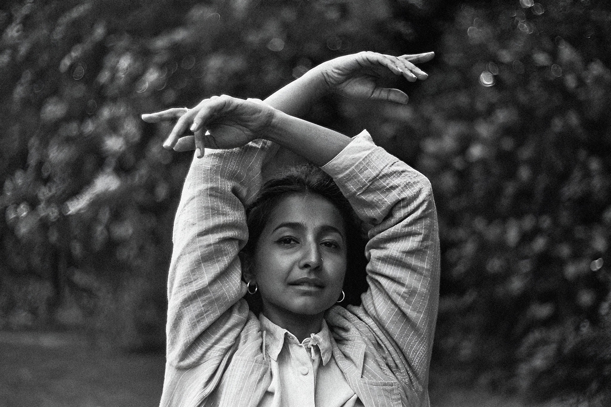 Singer-singwriter Ditty aka Aditi Veena in a black and white photo with arms raised