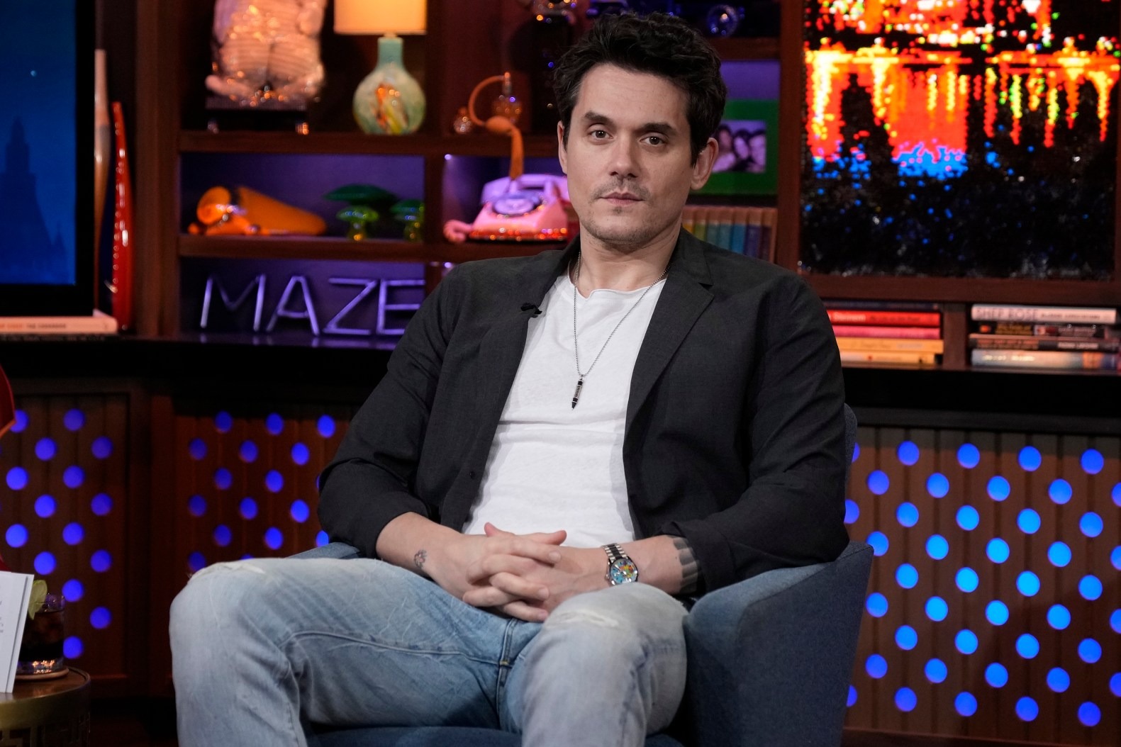 John Mayer seated on the Andy Cohen show Watch What Happens Live