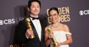 Steven Yeun and Ali Wong pose with awards