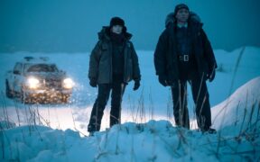 Jodie Foster and Kali Reis wearing jackets walking in the snow in a still from 'True Detective' Season 4