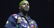 Rapper A$AP Ferg in a blue shirt with colorful stickers and green hair