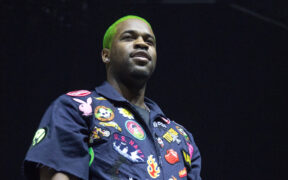 Rapper A$AP Ferg in a blue shirt with colorful stickers and green hair