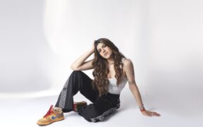 Ananya Birla in black pants and white top posing for photo