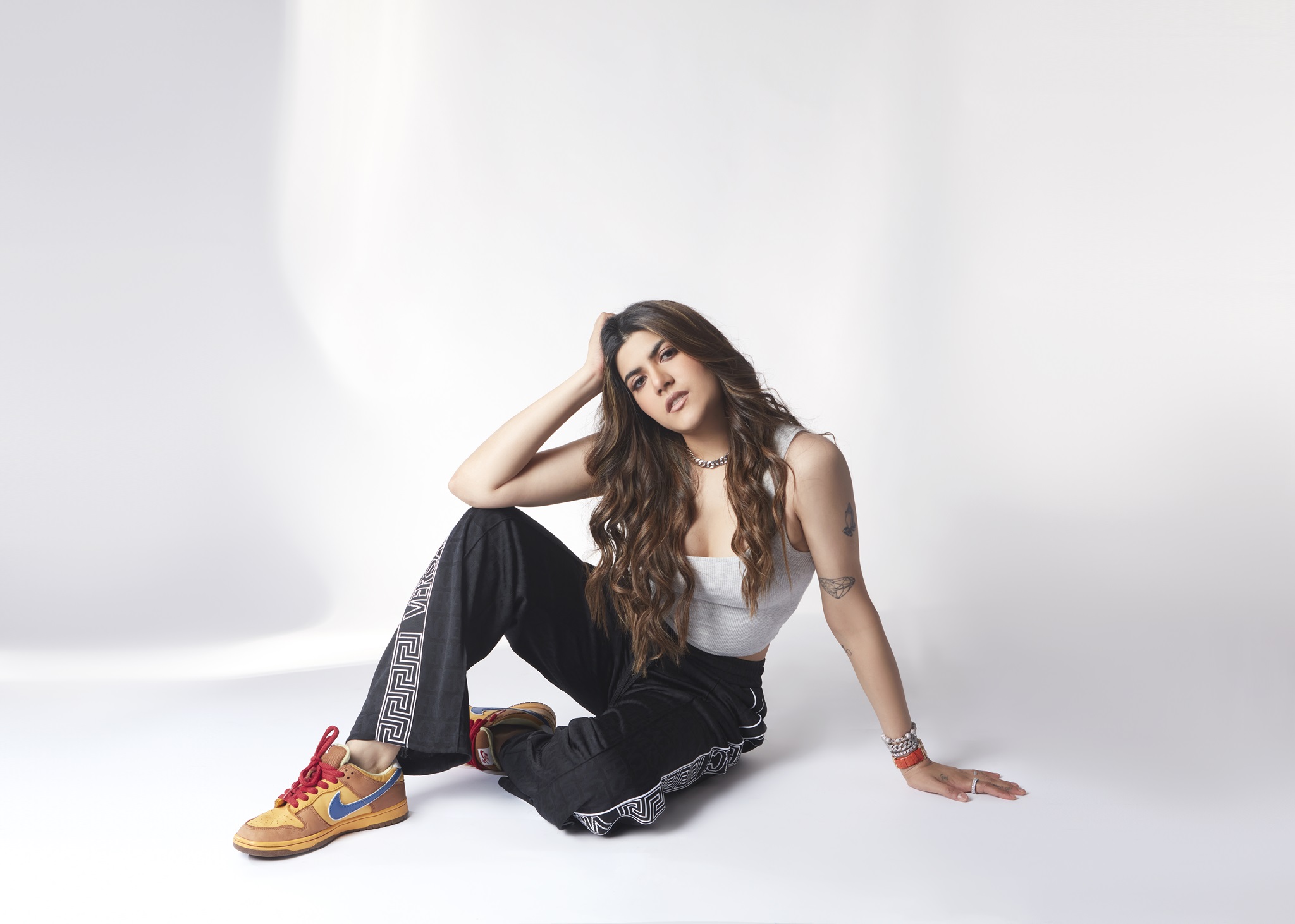 Ananya Birla in black pants and white top posing for photo