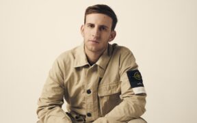 American DJ producer Illenium in khaki shirt and trousers