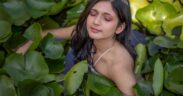 Music artist Swati Bhatt in a water body surrounded by leaves