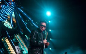 AR Rahman in a black suit wearing sunglasses on stage