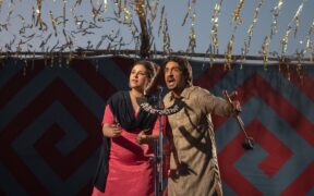 Parineeti Chopra and Diljit Dosanjh singing in front of mic in the Netflix movie Amar Singh Chamkila