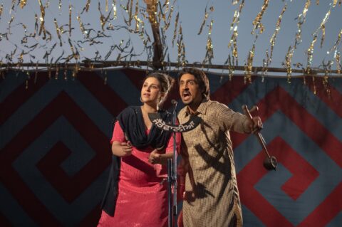 Parineeti Chopra and Diljit Dosanjh singing in front of mic in the Netflix movie Amar Singh Chamkila