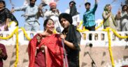 Raja Kumari in red churidar with Guru Randhawa in black suit and turban