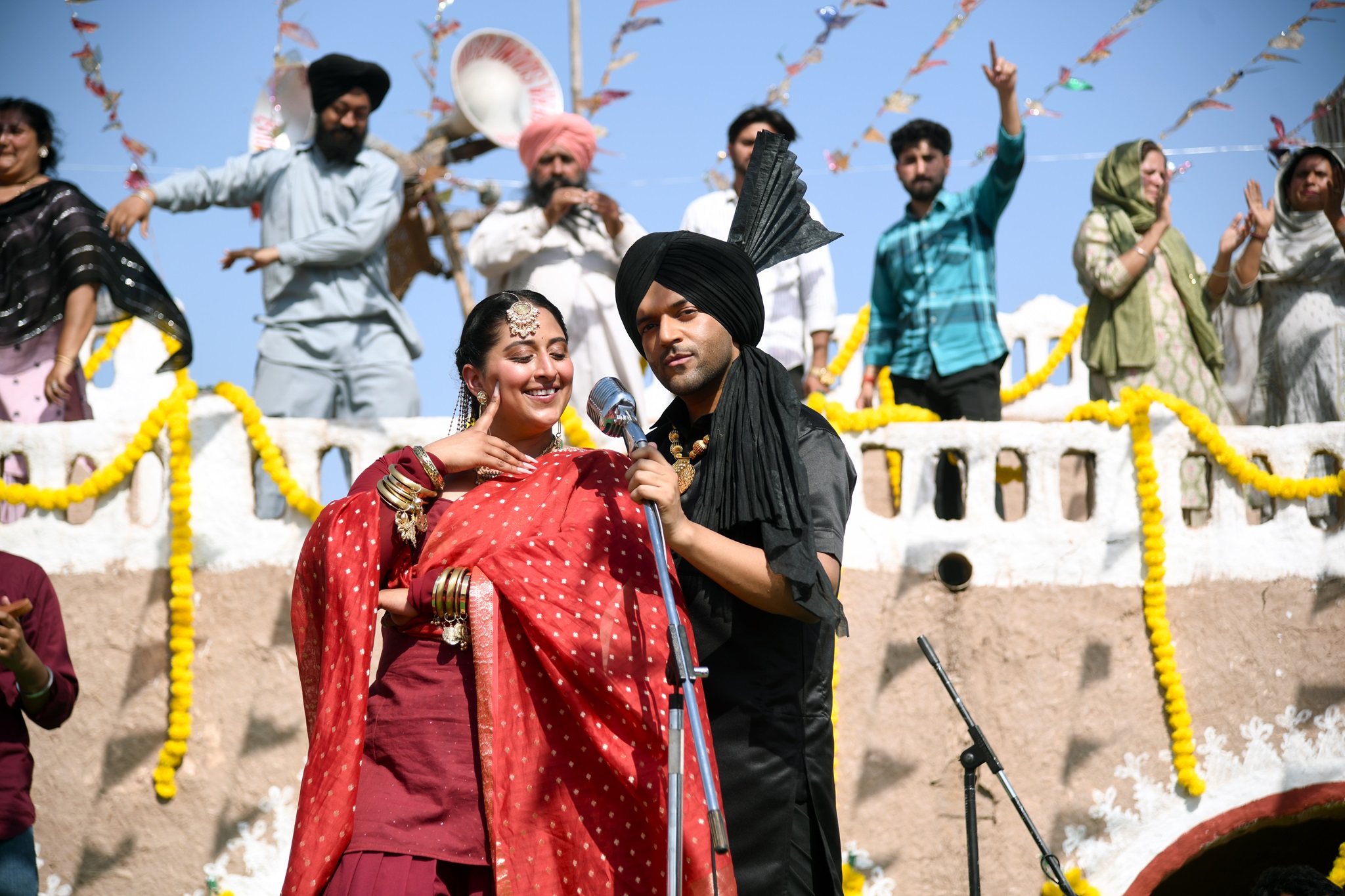 Raja Kumari in red churidar with Guru Randhawa in black suit and turban