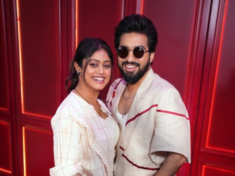 Parampara Tandon and Sachet Tandon wearing white in red background smiling