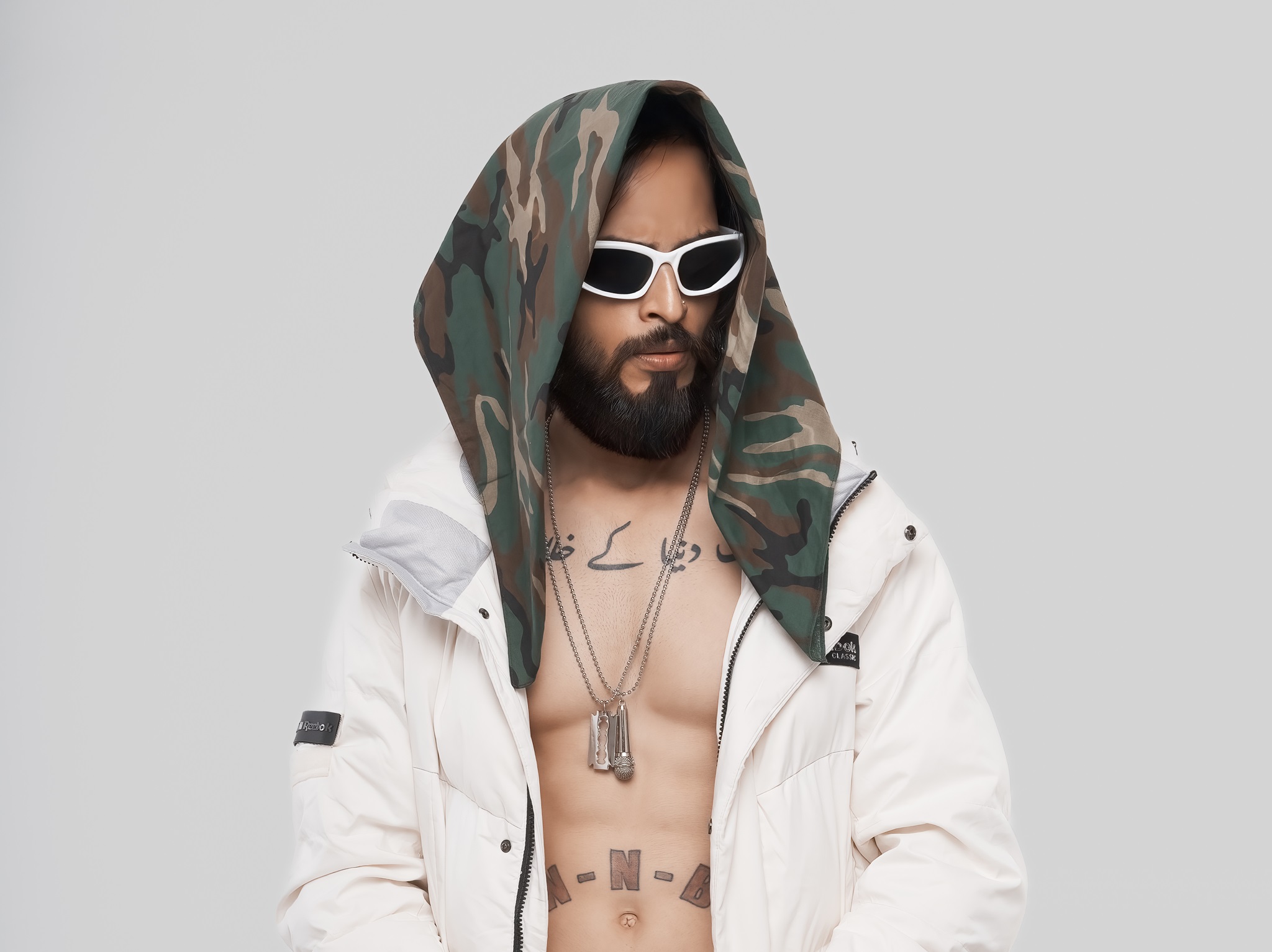 Mumbai hip-hop artist Shaikhspeare wearing white jacket and black hood bandana