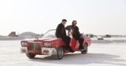 Guru Randhawa and Babbu Maan sitting on a red convertible car in the Pagal music video