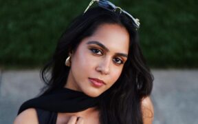 Tamil indie artist Sandhya Chari wearing black and sunglasses on hair