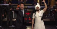 Jimmy Fallon speaks with Diljit Dosanjh with band members in the background on the Tonight Show