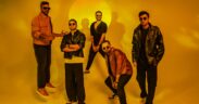 The Yellow Diary band members in jackets and sunglasses posing with yellow tint background